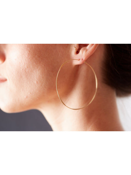 These classic hammered hoops are the perfect statement-making pair to add to a modern, casual collection. The thin gold-fill hoops feature an organic, hammered texture and quality craftsmanship. 14k gold fill
